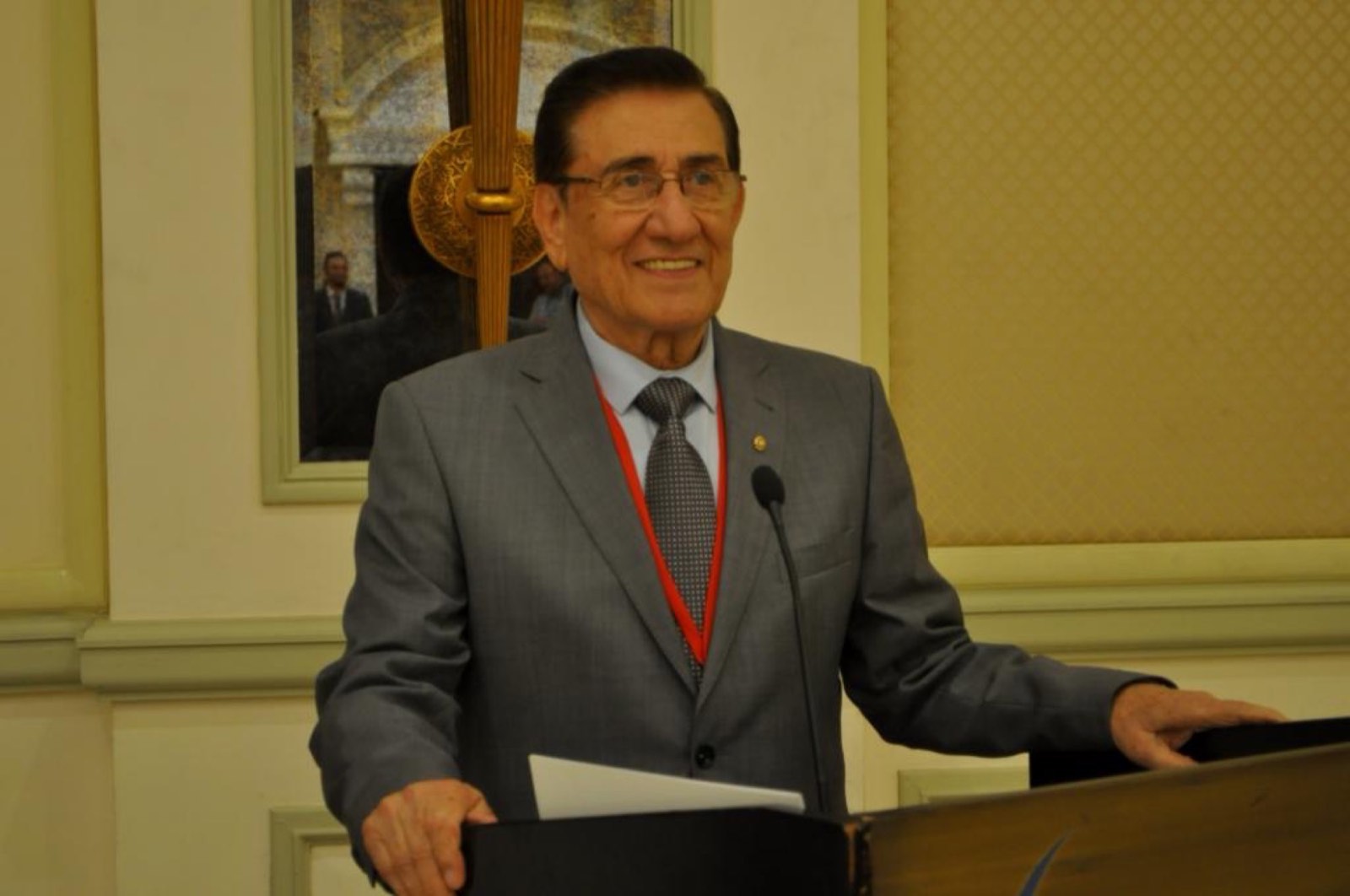 Walid Zabadne speaking from a lectern at a Zabadne Sterling event in Dubai